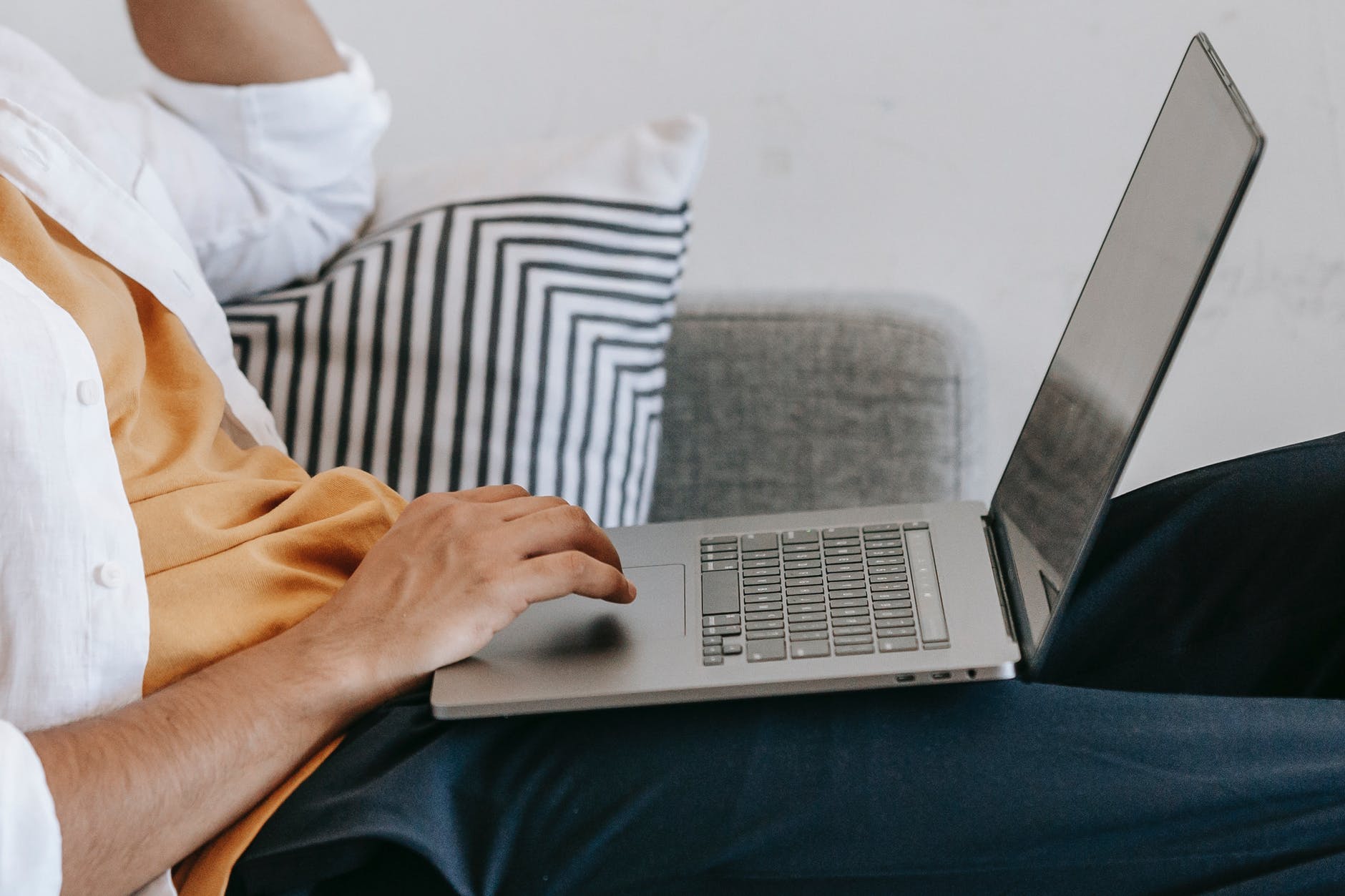 teen using touchpad on laptop during private online homeschool for kids