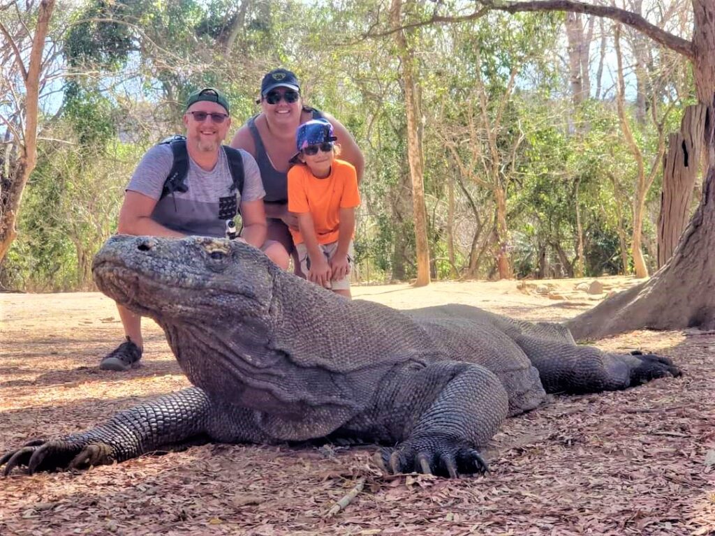 Family photo on Komodo Island, Indonesia. Our family of three behind a large Komodo dragon.