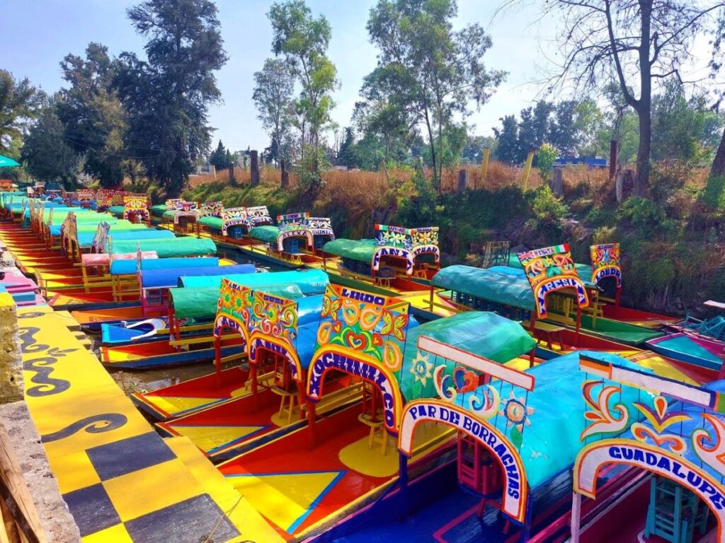 A long row of gondolas tied together, not being used at Xochimilco. Photo was taken early in the morning before most tourists arrived.