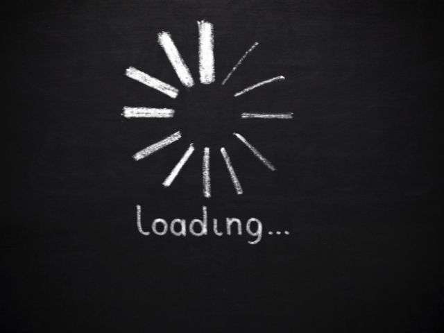 Black chalkboard style background with the word "loading..." in white with a white, chalk drawn sunlike image above it to symbolize the loading process.