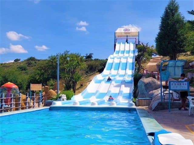 Tall waterslides at Xote waterpark in San Miguel de Allende with kids.