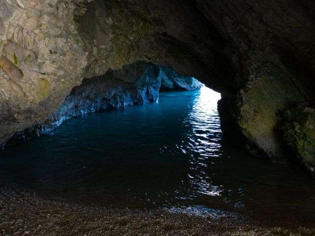 Watch the tides when exploring beach caves in El Tunco, El Salvador.