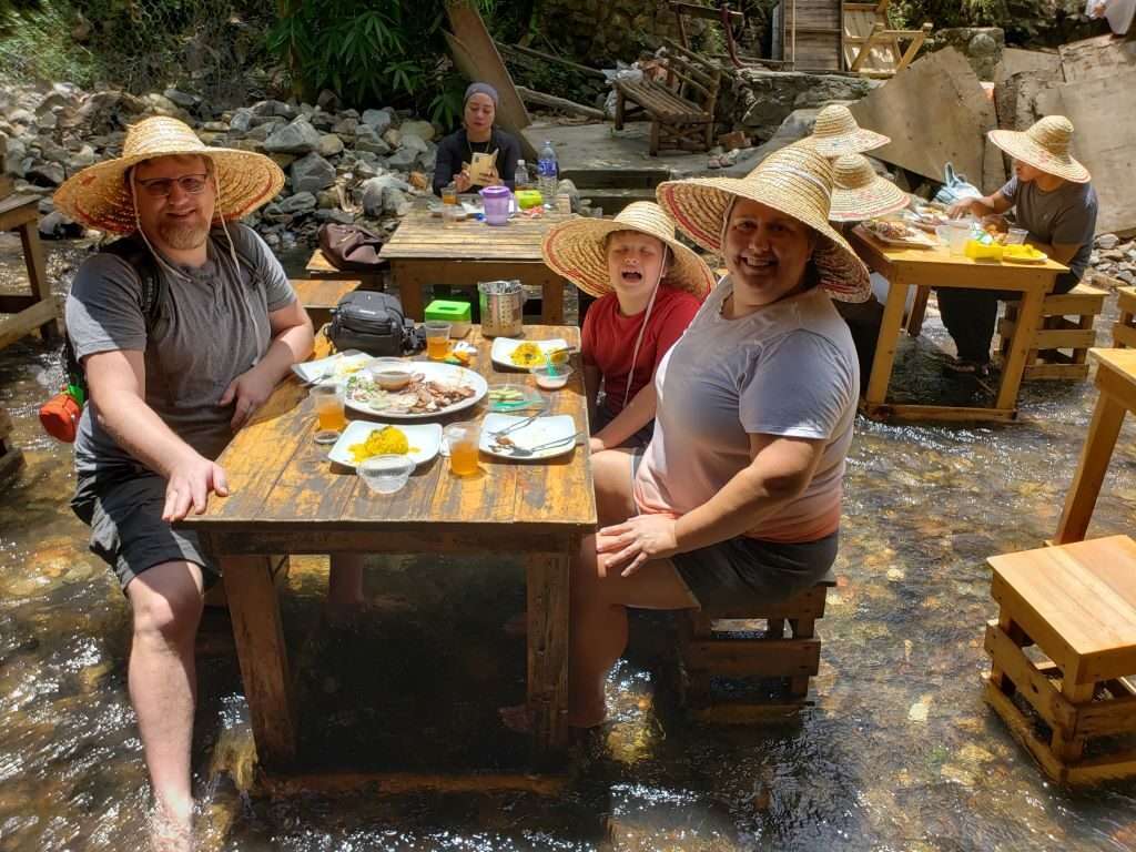 My family eating lunch in a river in Kuala Lumpur