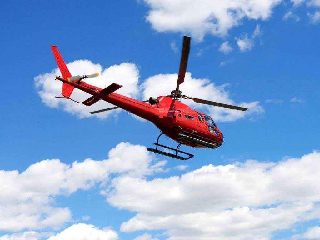 Red helicopter flying