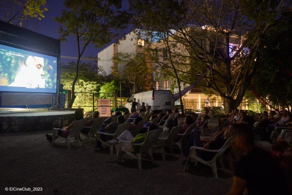 Outdoor movie theater with people watching a movie