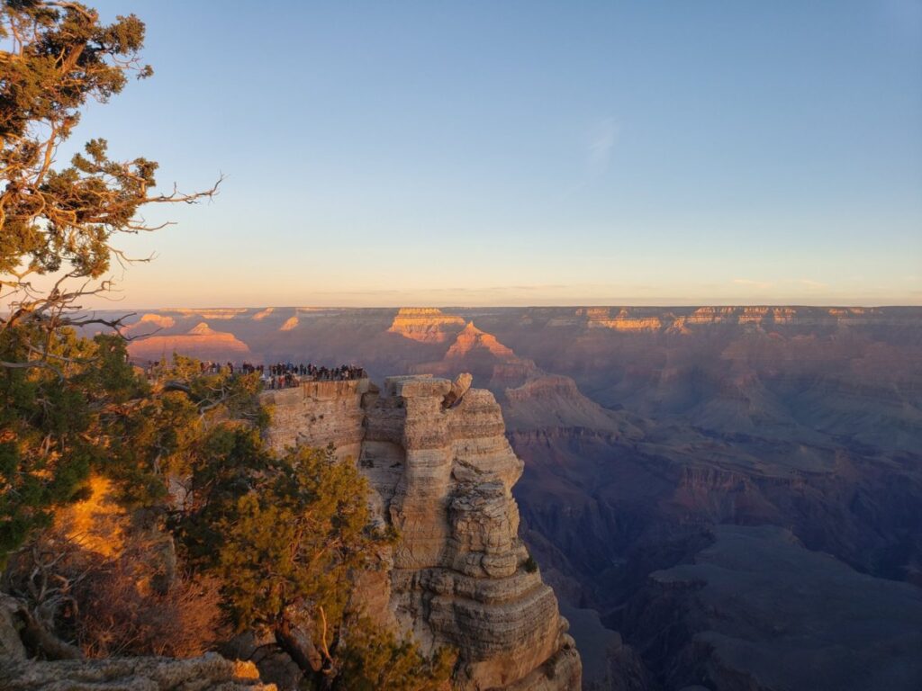 Crowded Mather Point at Sunset. With private Grand Canyon tours from Las Vegas you don't have to worry about being stuck with big groups like that.