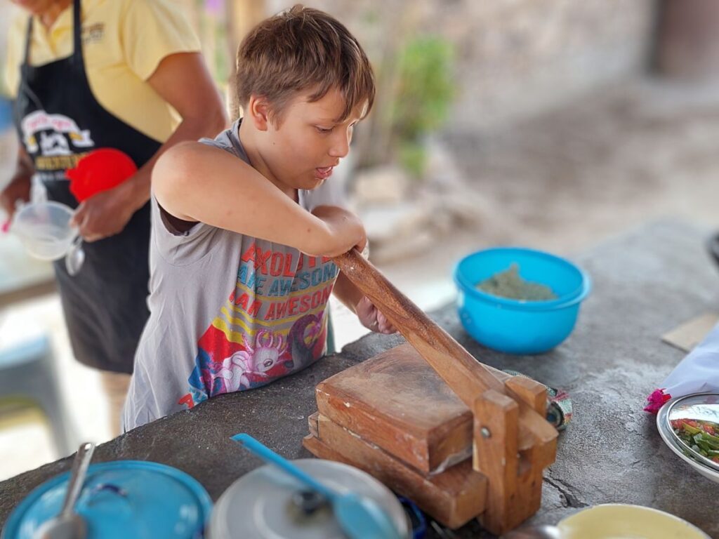 Little Man making tortillas in a cooking class