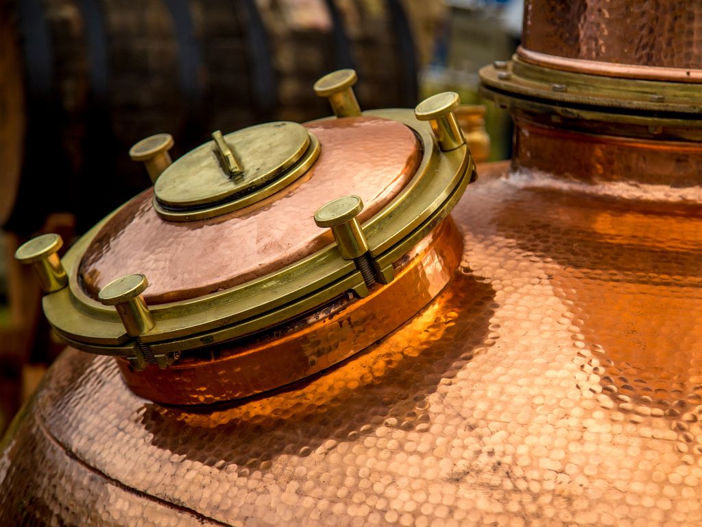 Close up shot of a copper vodka distilling barrel
