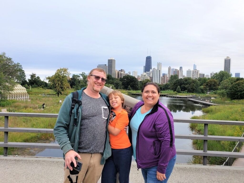 Family photo in Lincoln Park with the Chicago skyline in the background.