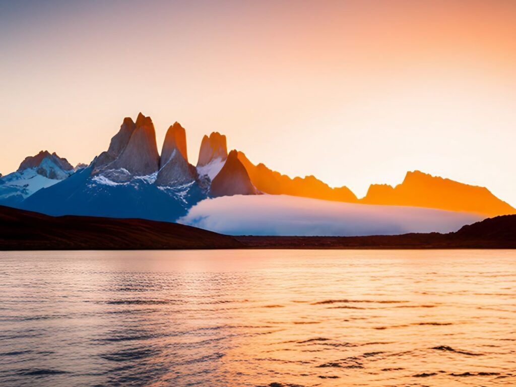 Serene mountains behind a calm lake at sunset.