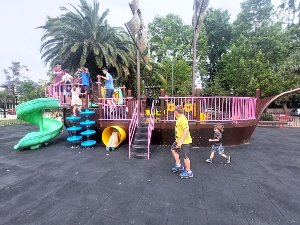 Little Man playing with a group of friends on a playground in Argentina