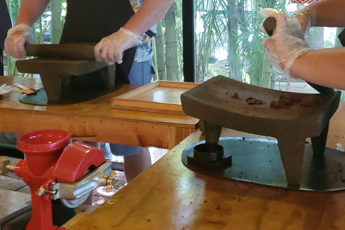 Hand grinding chocolate with roller.