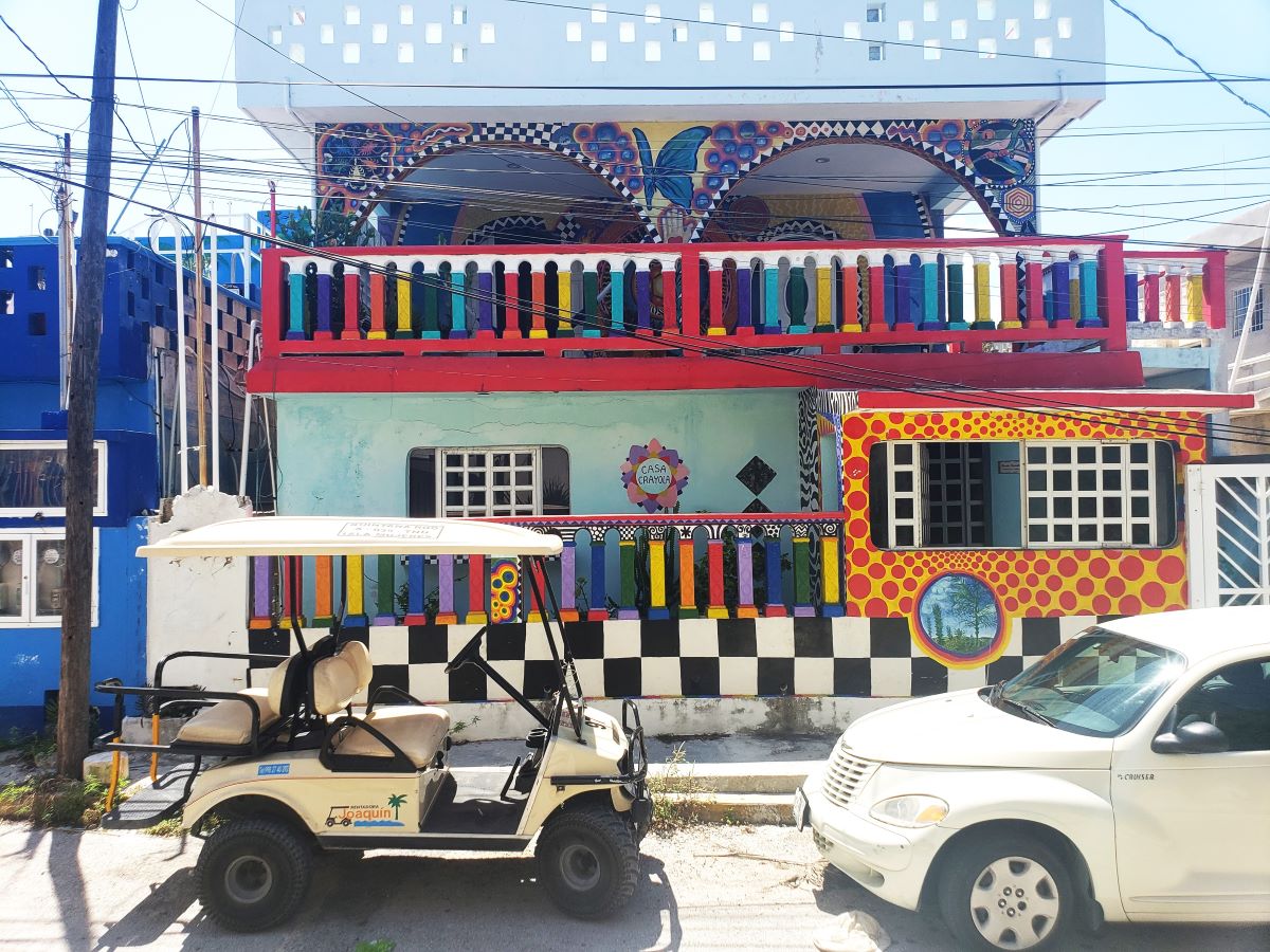 Our rental golf cart in front of the Crayola House on Isla Mujeres with kids