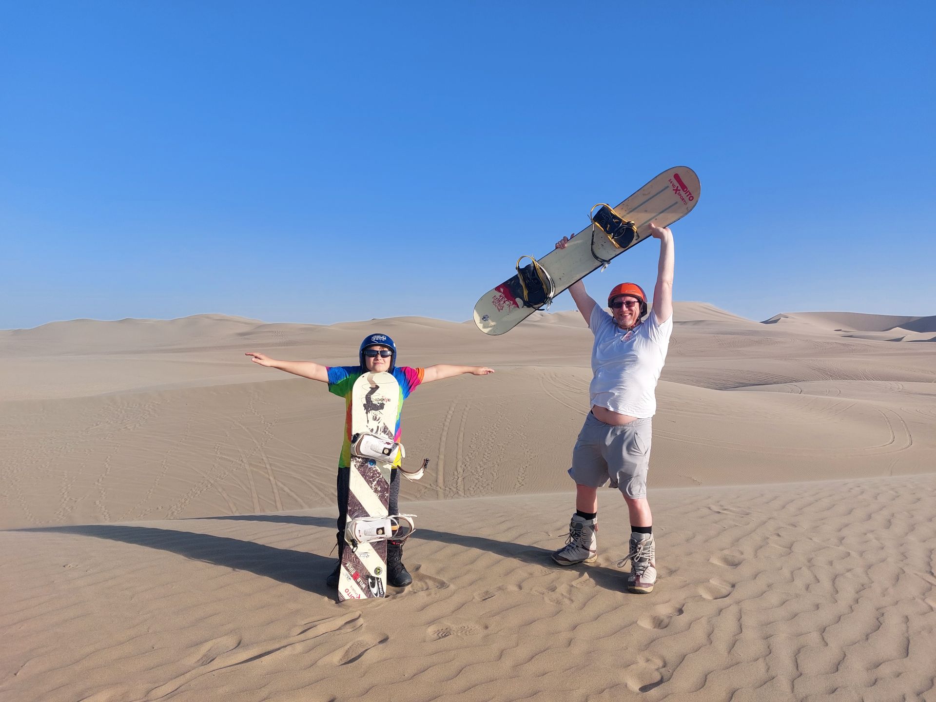 Little Man and David sandboarding in Huacachina Peru